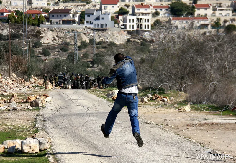 Palestinian protesters clash with Israeli forces during a protest in the village of Kufr Qaddum near the Israeli settlement of Kdumim, in the northern West Bank, Friday, Dec. 2, 2011. Photo by Wagdi Eshtayah