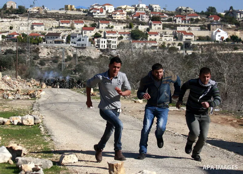 Palestinian protesters clash with Israeli forces during a protest in the village of Kufr Qaddum near the Israeli settlement of Kdumim, in the northern West Bank, Friday, Dec. 2, 2011. Photo by Wagdi Eshtayah