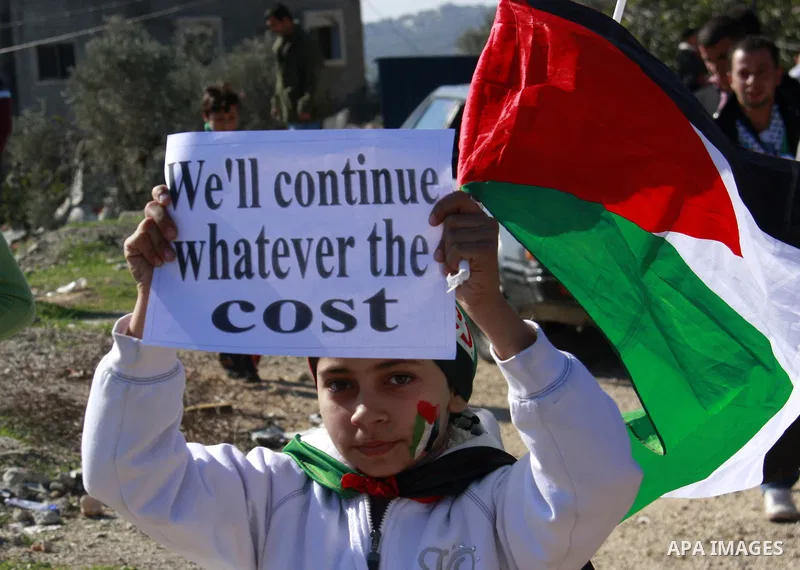 Palestinian protesters clash with Israeli forces during a protest in the village of Kufr Qaddum near the Israeli settlement of Kdumim, in the northern West Bank, Friday, Dec. 2, 2011. Photo by Wagdi Eshtayah