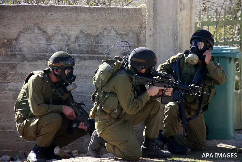 Israeli border police officers fire tear gas towards Palestinian demonstrators, not seen, during a protest in the village of Kufr Qaddum near the Israeli settlement of Kdumim, in the northern West Bank, Friday, Dec. 2, 2...