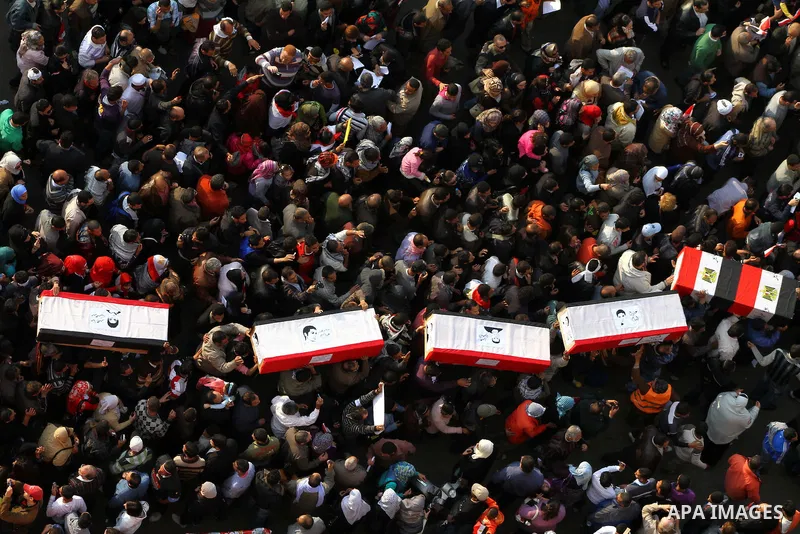 Egyptian protesters carry symbolic coffins honoring those killed in recent clashes with security forces during a rally in Tahrir Square, in Cairo, Egypt, Friday, Dec. 2, 2011. Islamists appear to have taken a strong majo...