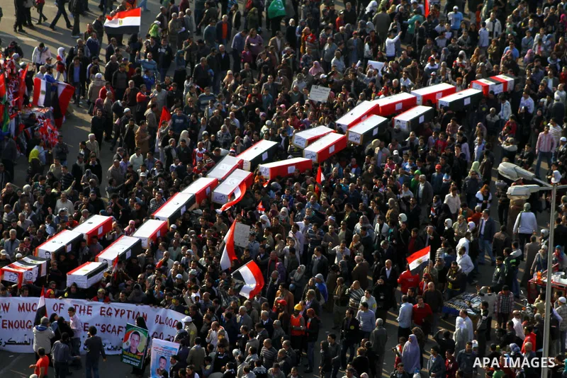 Egyptian protesters carry symbolic coffins honoring those killed in recent clashes with security forces during a rally in Tahrir Square, in Cairo, Egypt, Friday, Dec. 2, 2011. Islamists appear to have taken a strong majo...