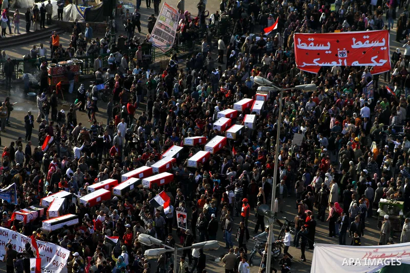 Egyptian protesters carry symbolic coffins honoring those killed in recent clashes with security forces during a rally in Tahrir Square, in Cairo, Egypt, Friday, Dec. 2, 2011. Islamists appear to have taken a strong majo...