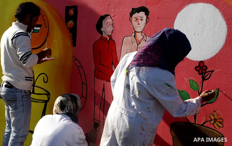 Palestinian Artists take part in paint a murals to mark the International Day for Persons with Disabilities on Dec. 03, 2011 in Gaza City.Photo by Mahmud Nassar