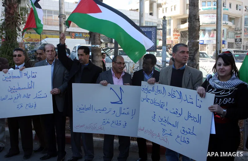 Palestinian journalists take part in a protest against the security forces of Hamas in Gaza Strip, in the West Bank city of Ramallah December 4, 2011. Photo by Issam Rimawi