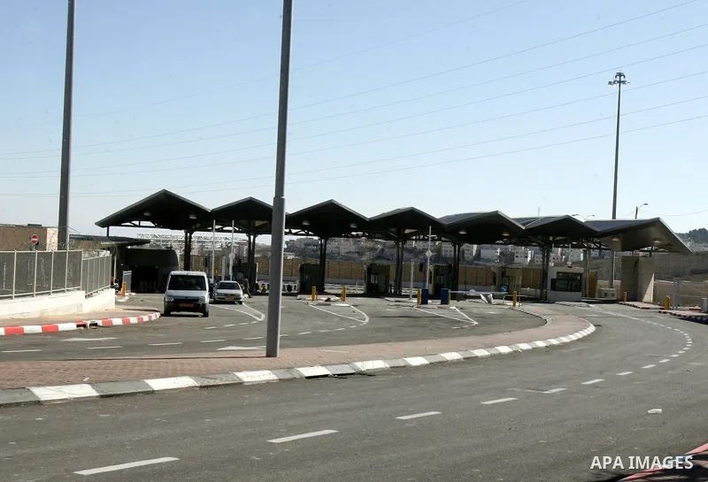 Palestinians are checked by Israeli soldiers at a new checkpoint in the east Jerusalem refugee camp of Shuafat on Dec. 4,2011. Photo by Mahfouz Abu Turk