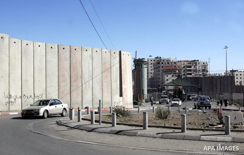 Palestinians are checked by Israeli soldiers at a checkpoint in the east Jerusalem refugee camp of Shuafat on Dec. 4,2011. Photo by Mahfouz Abu Turk