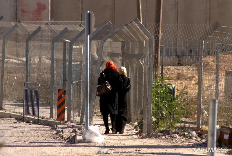 Palestinians cross through an Israeli checkpoint in the east Jerusalem refugee camp of Shuafat on Dec. 4,2011. Photo by Mahfouz Abu Turk