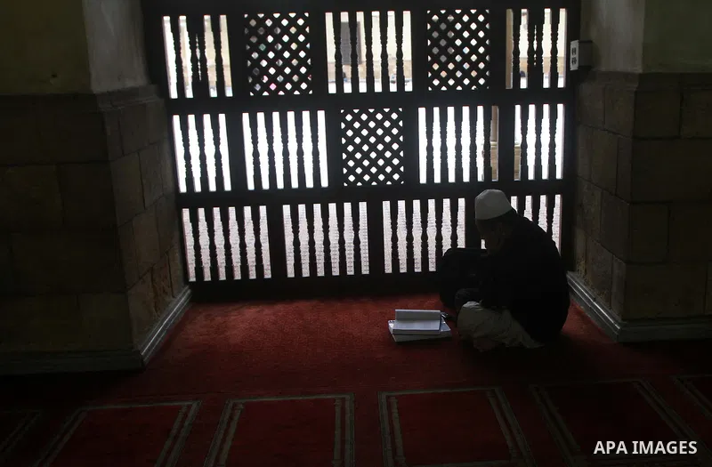 An Indonesian Muslim student reads from the Koran, Islam's holy book at Al-Azhar mosque in the old city of Cairo on December 4, 2011. Al-Azhar mosque, which was developed into one of the oldest Islamic universities, pays...