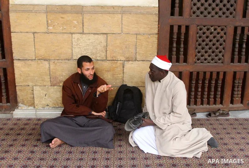Muslims sit at the yard of Al-Azhar mosque in the old city of Cairo on December 4, 2011. Al-Azhar mosque, which was developed into one of the oldest Islamic universities, pays special attention to the Quranic sciences an...
