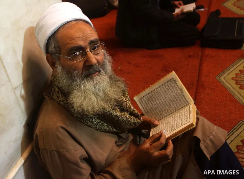 A Muslim man reads from the Koran, Islam's holy book at Al-Azhar mosque in the old city of Cairo on December 4, 2011. Al-Azhar mosque, which was developed into one of the oldest Islamic universities, pays special attenti...