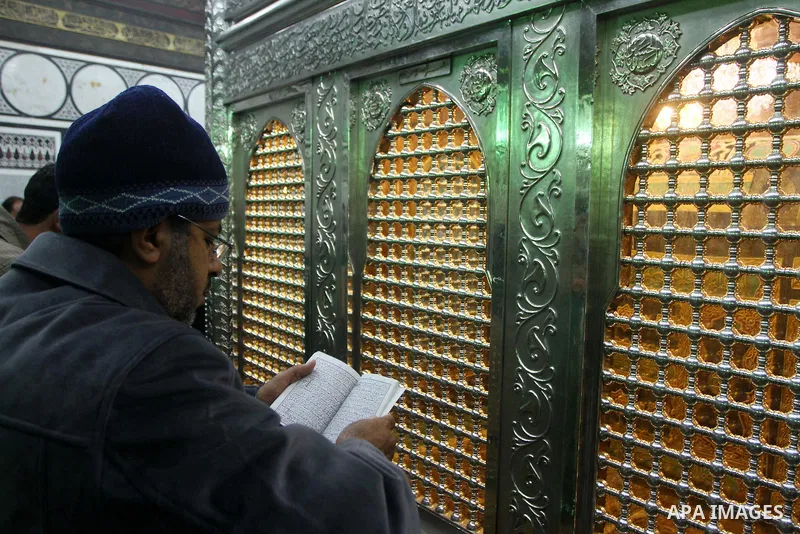 Egyptian Muslims pray at a tomb in al-Hussein mosque, which according to the belief head of Imam Hussein, the grandson of prophet Mohammed, is buried, in the old city of Cairo on December 4, 2011. Photo by Ashraf Amra