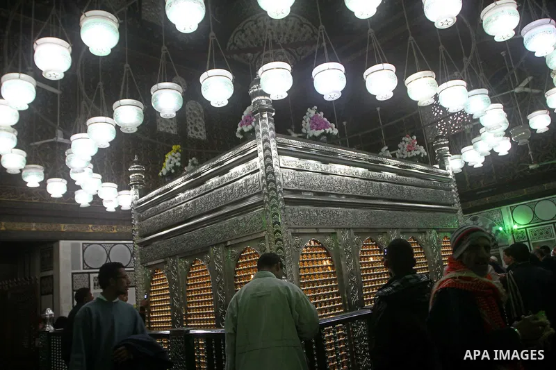Egyptian Muslims pray at a tomb in al-Hussein mosque, which according to the belief head of Imam Hussein, the grandson of prophet Mohammed, is buried, in the old city of Cairo on December 4, 2011. Photo by Ashraf Amra