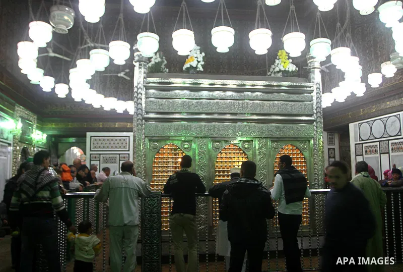 Egyptian Muslims pray at a tomb in al-Hussein mosque, which according to the belief head of Imam Hussein, the grandson of prophet Mohammed, is buried, in the old city of Cairo on December 4, 2011. Photo by Ashraf Amra