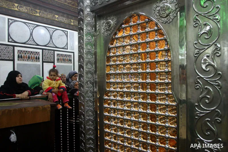 Egyptian Muslims pray at a tomb in al-Hussein mosque, which according to the belief head of Imam Hussein, the grandson of prophet Mohammed, is buried, in the old city of Cairo on December 4, 2011. Photo by Ashraf Amra