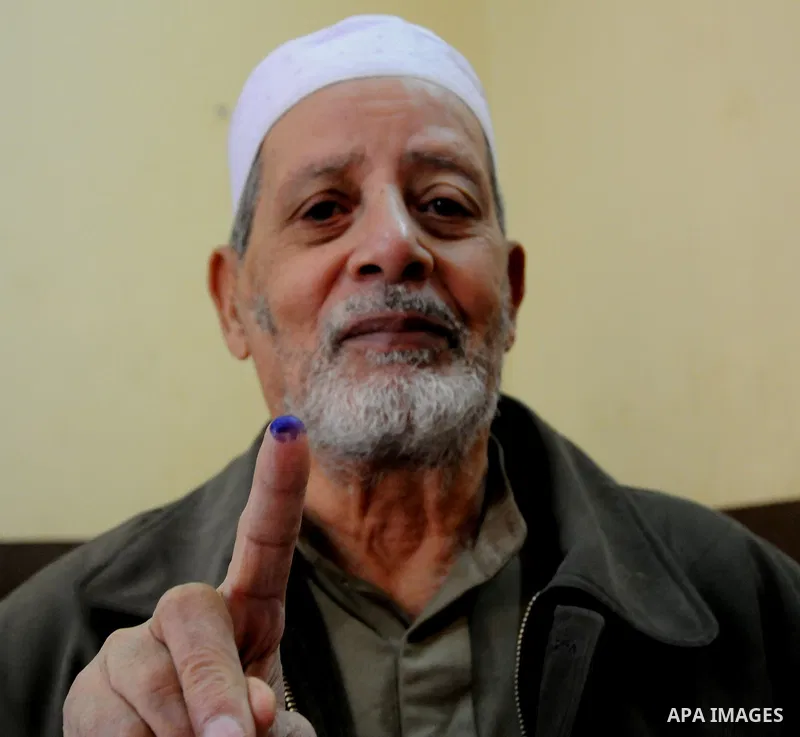 Egyptians cast their ballot at a parliamentary polling station in the run-off of the first round of voting in the Cairo neighbourhood of Bab El-Shaeria on December 5, 2011. Islamist candidates in Egypt looked to extend t...