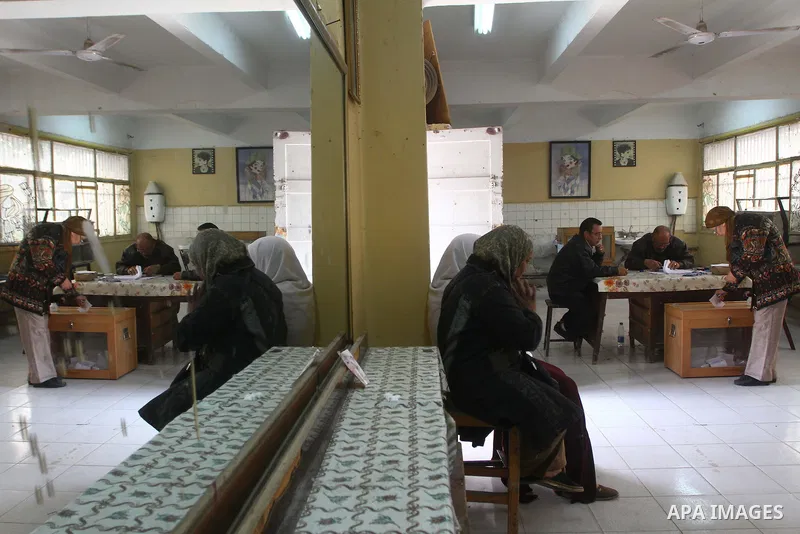 An Egyptian woman votes at a polling center during the first day of runoffs in Cairo, Egypt, Monday, Dec. 5, 2011. A trickle of Egyptian voters headed to the polls Monday for two days of runoffs in the country's first pa...