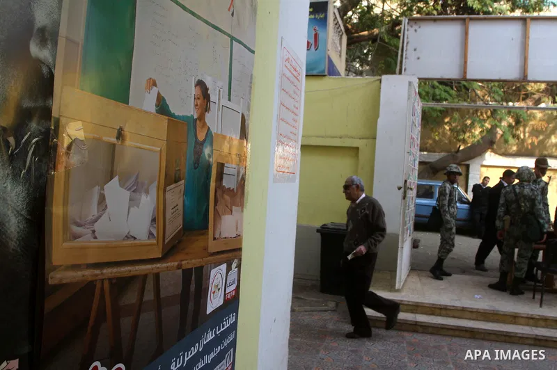 An Egyptian woman votes at a polling center during the first day of runoffs in Cairo, Egypt, Monday, Dec. 5, 2011. A trickle of Egyptian voters headed to the polls Monday for two days of runoffs in the country's first pa...