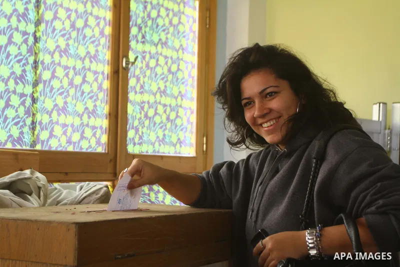 An Egyptian woman votes at a polling center during the first day of runoffs in Cairo, Egypt, Monday, Dec. 5, 2011. A trickle of Egyptian voters headed to the polls Monday for two days of runoffs in the country's first pa...