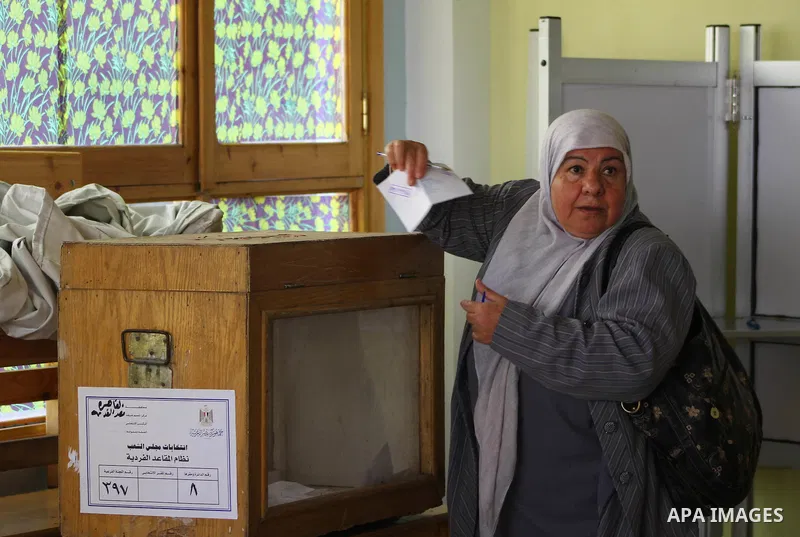 An Egyptian woman votes at a polling center during the first day of runoffs in Cairo, Egypt, Monday, Dec. 5, 2011. A trickle of Egyptian voters headed to the polls Monday for two days of runoffs in the country's first pa...