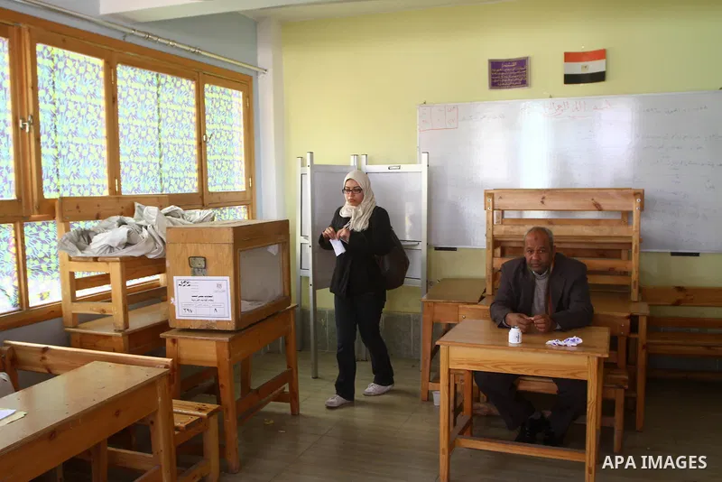 An Egyptian woman votes at a polling center during the first day of runoffs in Cairo, Egypt, Monday, Dec. 5, 2011. A trickle of Egyptian voters headed to the polls Monday for two days of runoffs in the country's first pa...