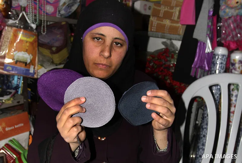 Palestinian women knit Kippas, traditional Jewish skullcaps, in the West Bank Village of Brukin near Nablus, Sunday, Dec. 05, 2011. The Palestinian women knit the Kippas in their West Bank village in order to sell them t...