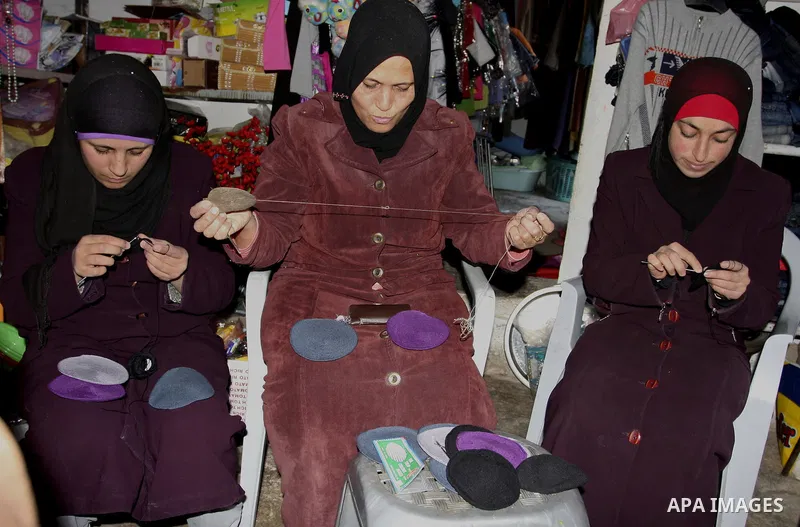 Palestinian women knit Kippas, traditional Jewish skullcaps, in the West Bank Village of Brukin near Nablus, Sunday, Dec. 05, 2011. The Palestinian women knit the Kippas in their West Bank village in order to sell them t...