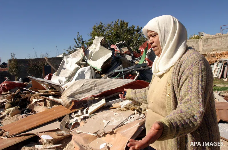 A Palestinian woman reacts after Israeli forces destroyed her family house in an area of the east Jerusalem neighborhood of Beit Hanina which falls in the West Bank side of Israel's separation barrier on Dec. 5, 2011. Ac...
