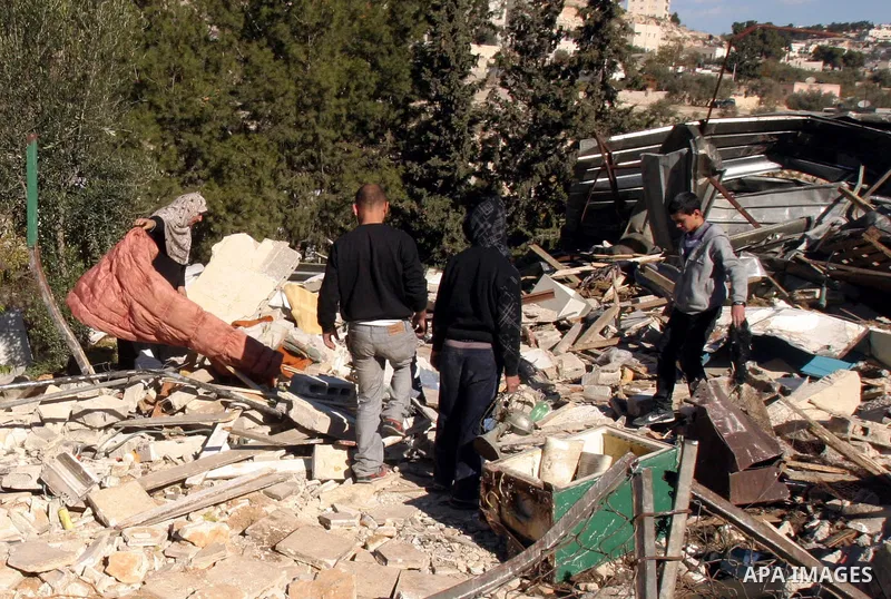 Palestinians inspect their belongings after Israeli forces destroyed their family house in an area of the east Jerusalem neighborhood of Silwan on Dec. 5, 2011. According to Israeli Authorities the house was built withou...