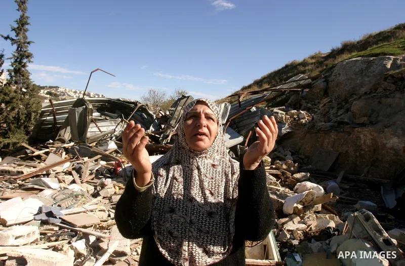 A Palestinian woman reacts after Israeli forces destroyed her family house in an area of the east Jerusalem neighborhood of Silwan on Dec. 5, 2011. According to Israeli Authorities the house was built without a permit. P...