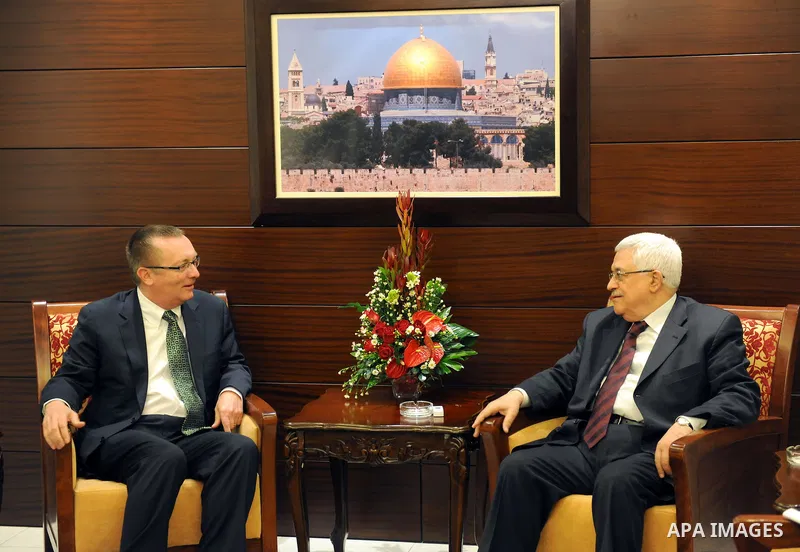 Palestinian President Mahmoud Abbas sits near the U.S. Assistant Secretary of State for Near East Affairs Jeffrey Feltman before their meeting in the West Bank city of Ramallah December 5, 2011. Photo by Thaer Ganaim
