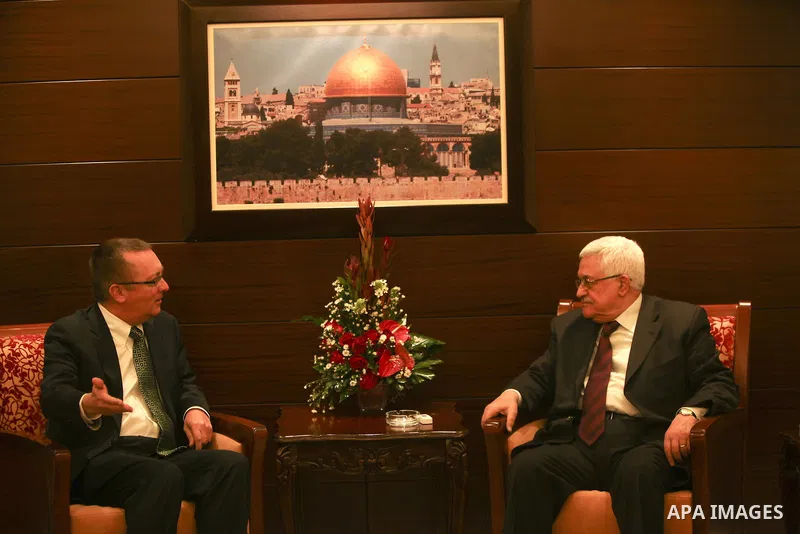 Palestinian President Mahmoud Abbas sits near the U.S. Assistant Secretary of State for Near East Affairs Jeffrey Feltman before their meeting in the West Bank city of Ramallah December 5, 2011. Photo by Issam Rimawi