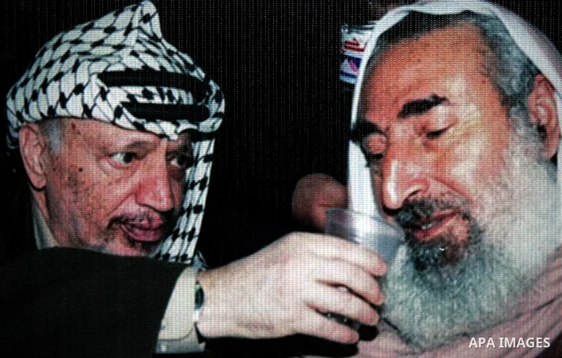 A picure to late Palestinian president Yasser Arafat with Sheikh Ahmed Yaseen is seen as Palestinian Hamas supporters gather at the Hamas founder home, Ahmed Yaseen to announce the starting of the launch of celebrations...