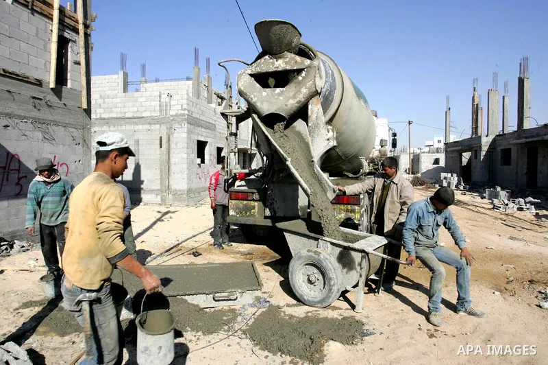 Palestinian laborours work to construct new houses in a project funded by the United Nations Relief and Works Agency for Palestine Refugees (UNRWA) in Rafah, in the southern of Gaza Strip on December 5, 2011. Israel main...