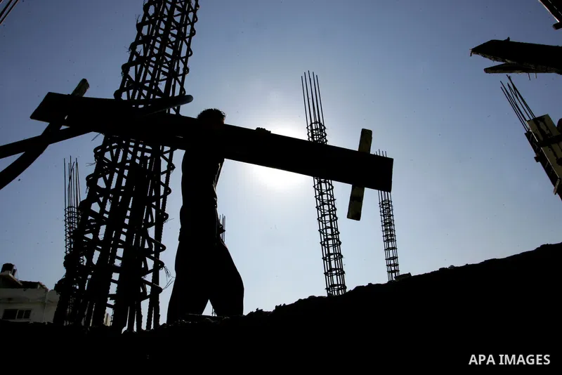 Palestinian laborours work to construct new houses in a project funded by the United Nations Relief and Works Agency for Palestine Refugees (UNRWA) in Rafah, in the southern of Gaza Strip on December 5, 2011. Israel main...