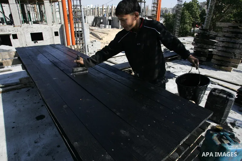 Palestinian laborours work to construct new houses in a project funded by the United Nations Relief and Works Agency for Palestine Refugees (UNRWA) in Rafah, in the southern of Gaza Strip on December 5, 2011. Israel main...