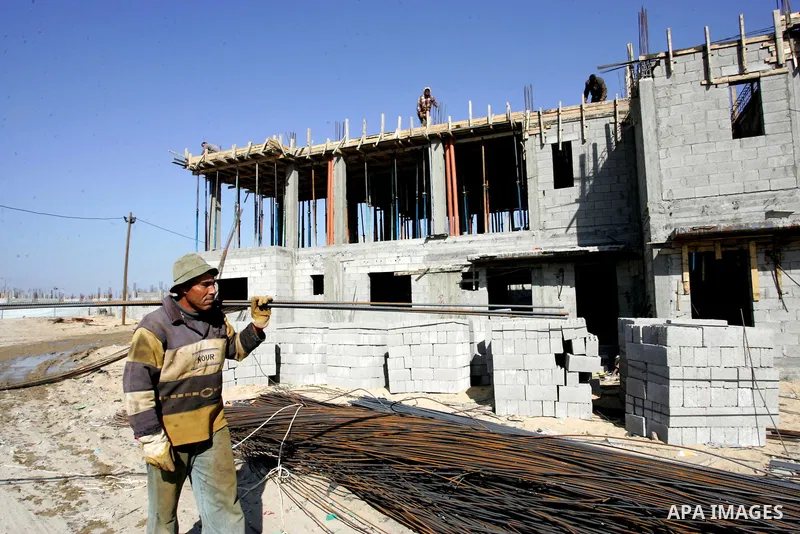Palestinian laborours work to construct new houses in a project funded by the United Nations Relief and Works Agency for Palestine Refugees (UNRWA) in Rafah, in the southern of Gaza Strip on December 5, 2011. Israel main...