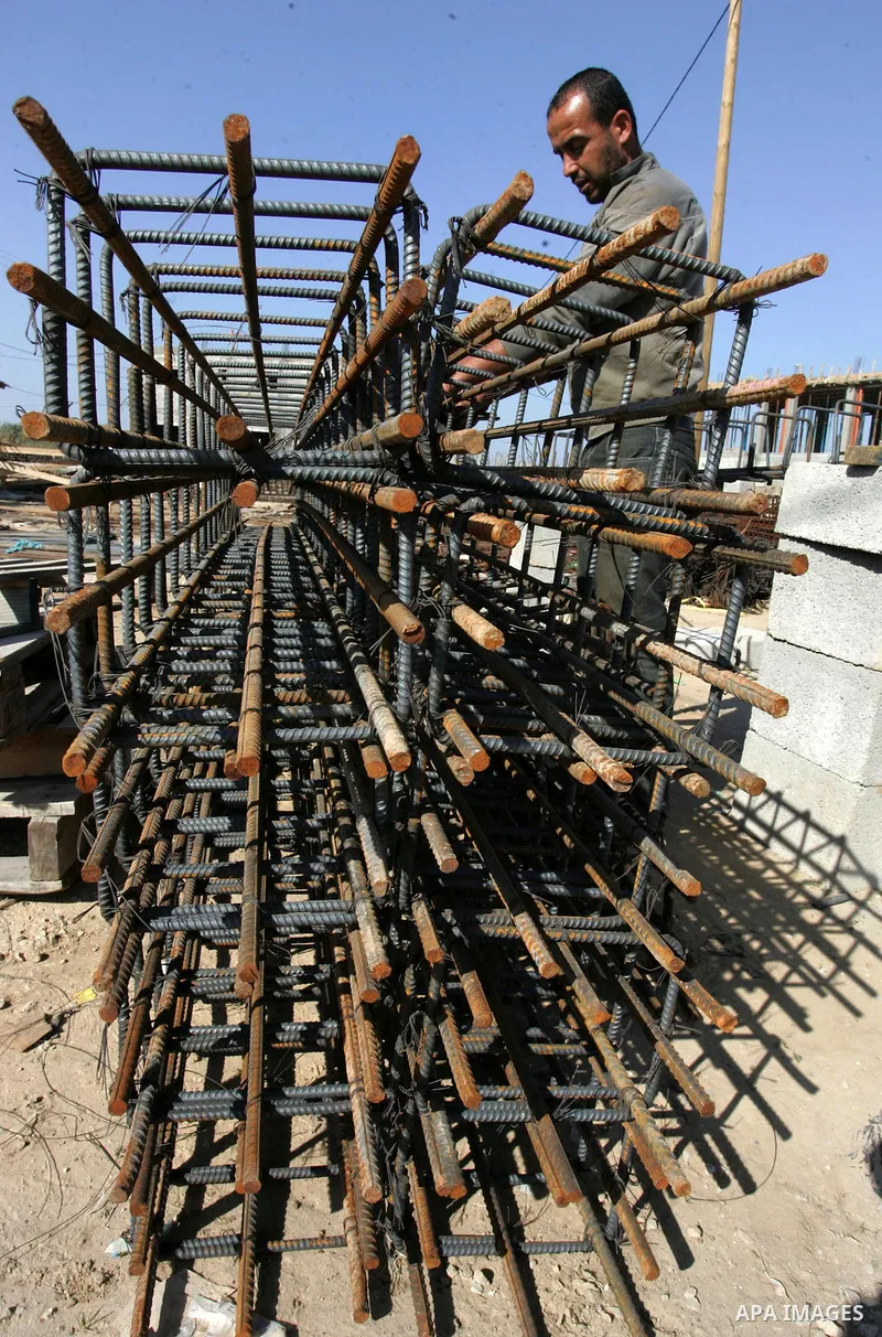Palestinian laborours work to construct new houses in a project funded by the United Nations Relief and Works Agency for Palestine Refugees (UNRWA) in Rafah, in the southern of Gaza Strip on December 5, 2011. Israel main...