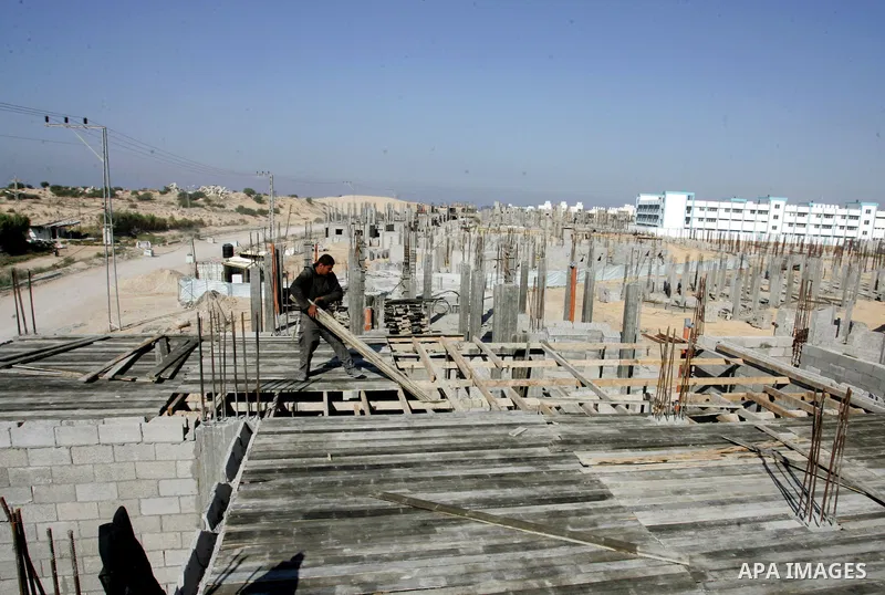 Palestinian laborours work to construct new houses in a project funded by the United Nations Relief and Works Agency for Palestine Refugees (UNRWA) in Rafah, in the southern of Gaza Strip on December 5, 2011. Israel main...
