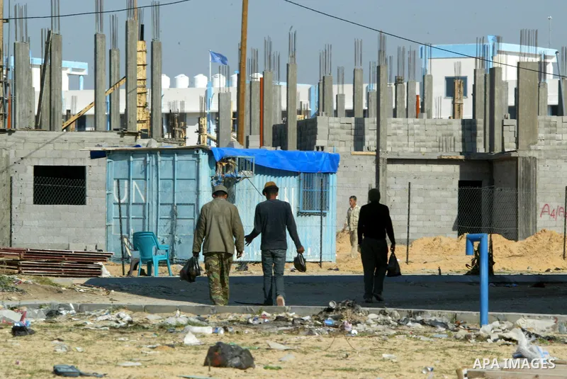 Palestinian laborours work to construct new houses in a project funded by the United Nations Relief and Works Agency for Palestine Refugees (UNRWA) in Rafah, in the southern of Gaza Strip on December 5, 2011. Israel main...