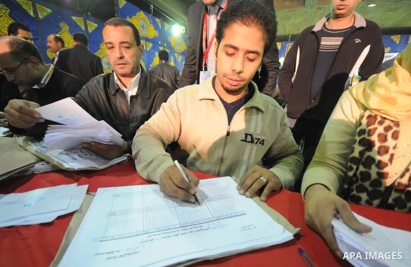 Egyptian election officials count ballots at the end the voting on the final day of the run-off for the first round of elections in Cairo on December 6, 2011. Photo by Ahmed Asad