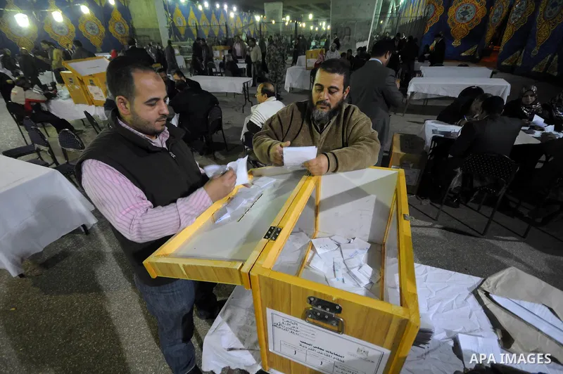 Egyptian election officials count ballots at the end the voting on the final day of the run-off for the first round of elections in Cairo on December 6, 2011. Photo by Ahmed Asad