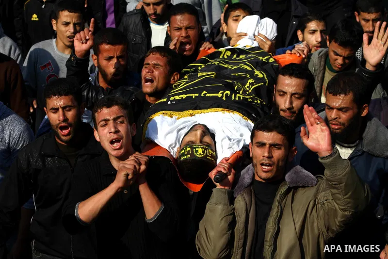 Palestinian mourners carry the body of Islamic Jihad militant Ismail Al-Areer during his funeral in Gaza City on December 7, 2011. A Palestinian was killed and five others were wounded by Israeli air strikes on the Gaza...