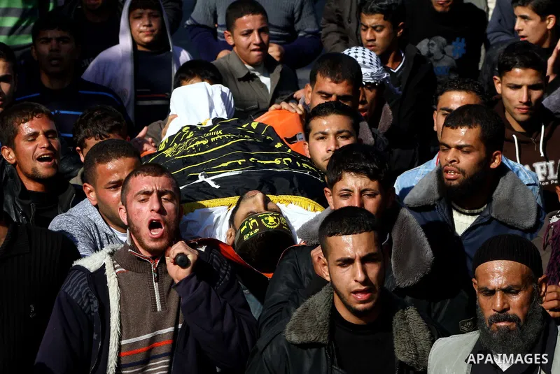 Palestinian mourners carry the body of Islamic Jihad militant Ismail Al-Areer during his funeral in Gaza City on December 7, 2011. A Palestinian was killed and five others were wounded by Israeli air strikes on the Gaza...