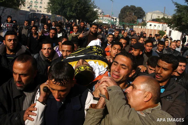 Palestinian mourners carry the body of Islamic Jihad militant Ismail Al-Areer during his funeral in Gaza City on December 7, 2011. A Palestinian was killed and five others were wounded by Israeli air strikes on the Gaza...