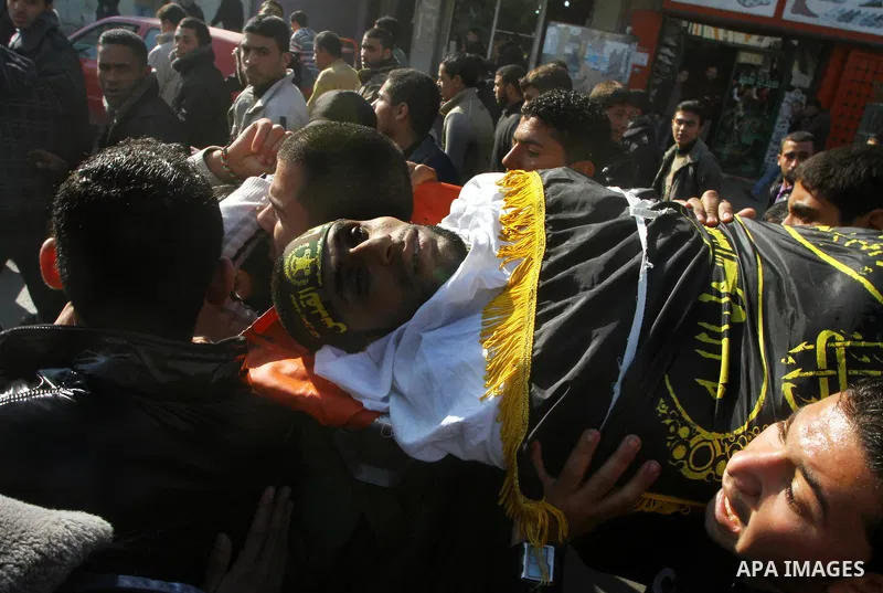 Palestinian mourners carry the body of Islamic Jihad militant Ismail Al-Areer during his funeral in Gaza City on December 7, 2011. A Palestinian was killed and five others were wounded by Israeli air strikes on the Gaza...