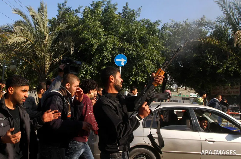A Palestinian man shots fire in the air during the funeral of Islamic Jihad gunman Ismail Al-Areer in Gaza City December 7, 2011. A Palestinian was killed and five others were wounded by Israeli air strikes on the Gaza S...