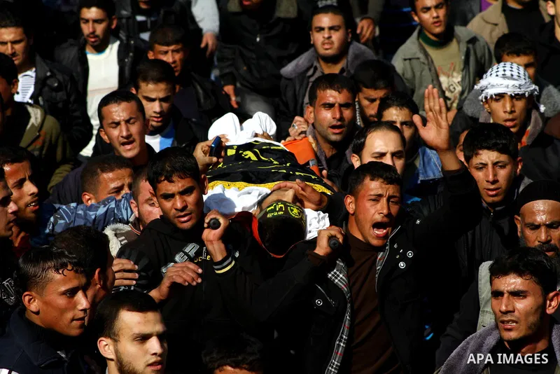 Palestinian mourners carry the body of Islamic Jihad militant Ismail Al-Areer during his funeral in Gaza City on December 7, 2011. A Palestinian was killed and five others were wounded by Israeli air strikes on the Gaza...