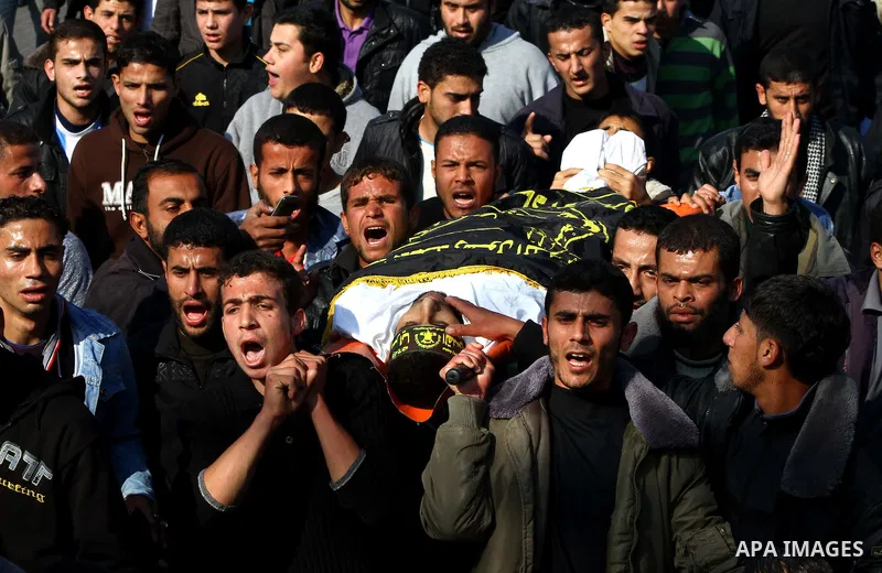 Palestinian mourners carry the body of Islamic Jihad militant Ismail Al-Areer during his funeral in Gaza City on December 7, 2011. A Palestinian was killed and five others were wounded by Israeli air strikes on the Gaza...