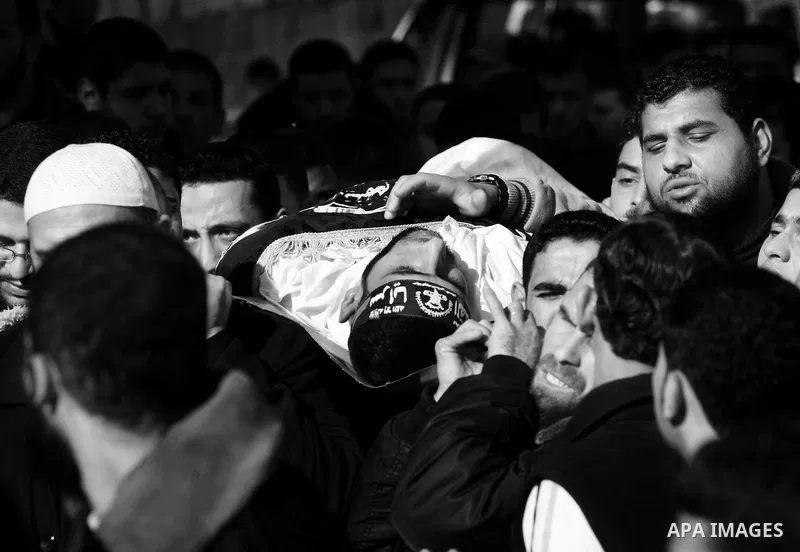 Palestinian mourners carry the body of Islamic Jihad militant Ismail Al-Areer during his funeral in Gaza City on December 7, 2011. A Palestinian was killed and five others were wounded by Israeli air strikes on the Gaza...